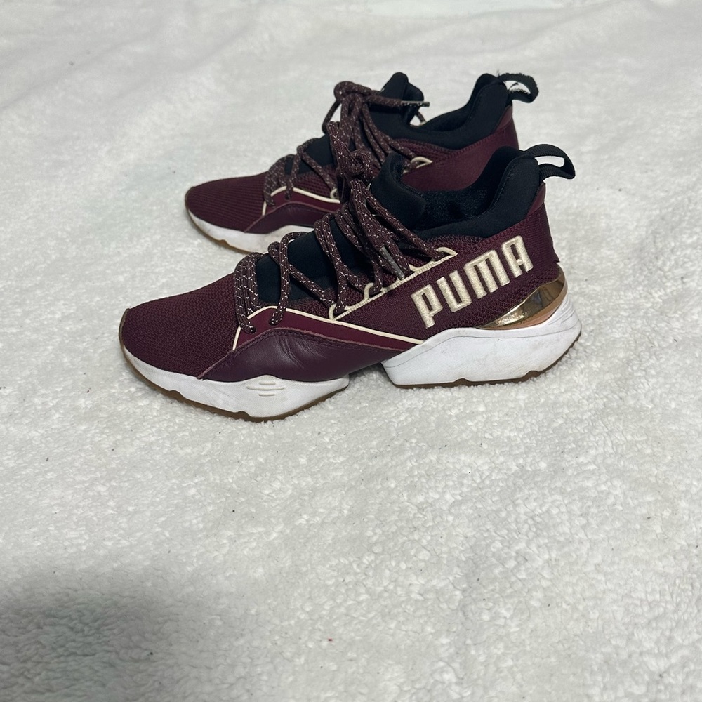 Puma maroon and gold women shoes.